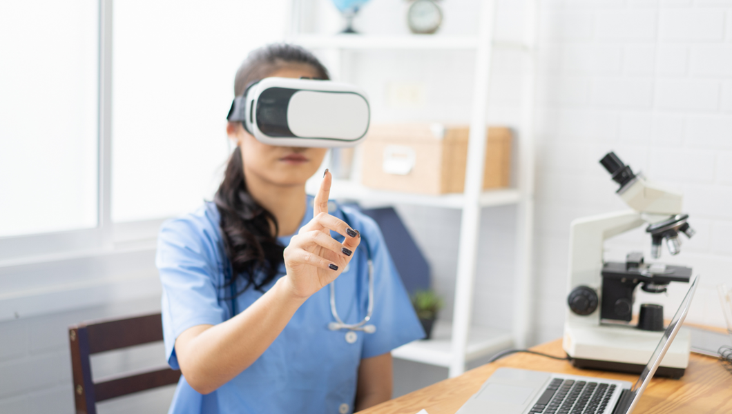 Healthcare worker wearing virtual reality headset looks at her outstretched finger