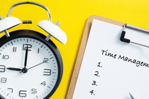 Clock and clipboard reading "Time Management" against yellow background